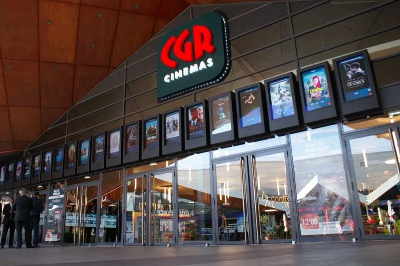 Cinema entrance with a row of digital movie posters