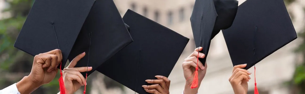 Graduation caps thrown in the air