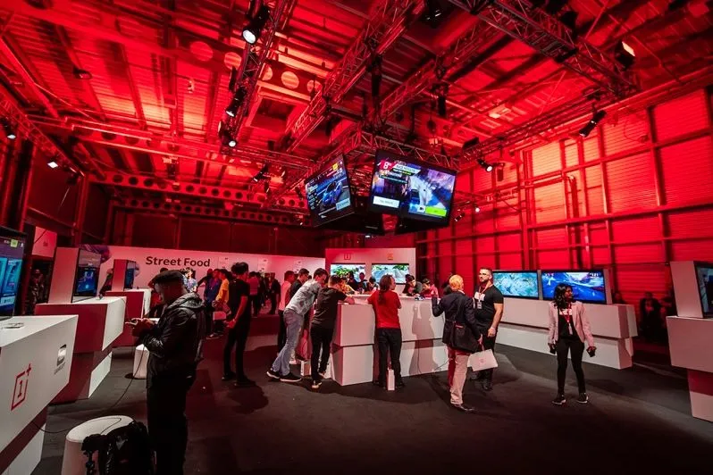 Concert venue lobby lit in red with screens above the bar