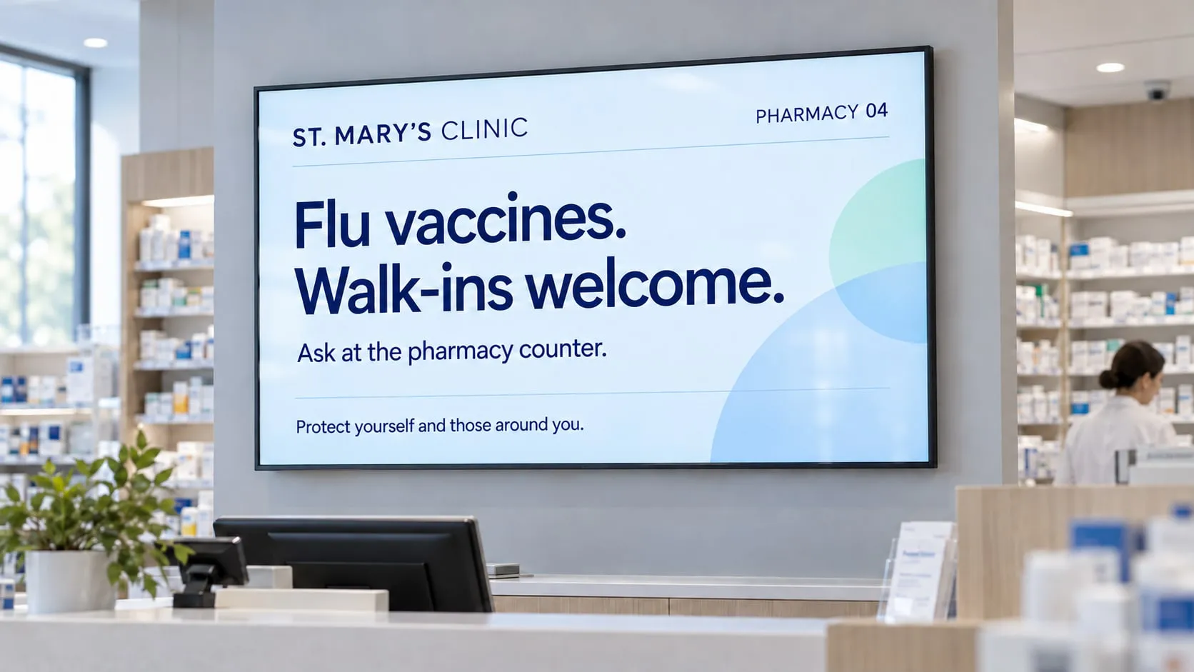 Pharmacy counter with a screen announcing flu vaccines and walk-ins welcome