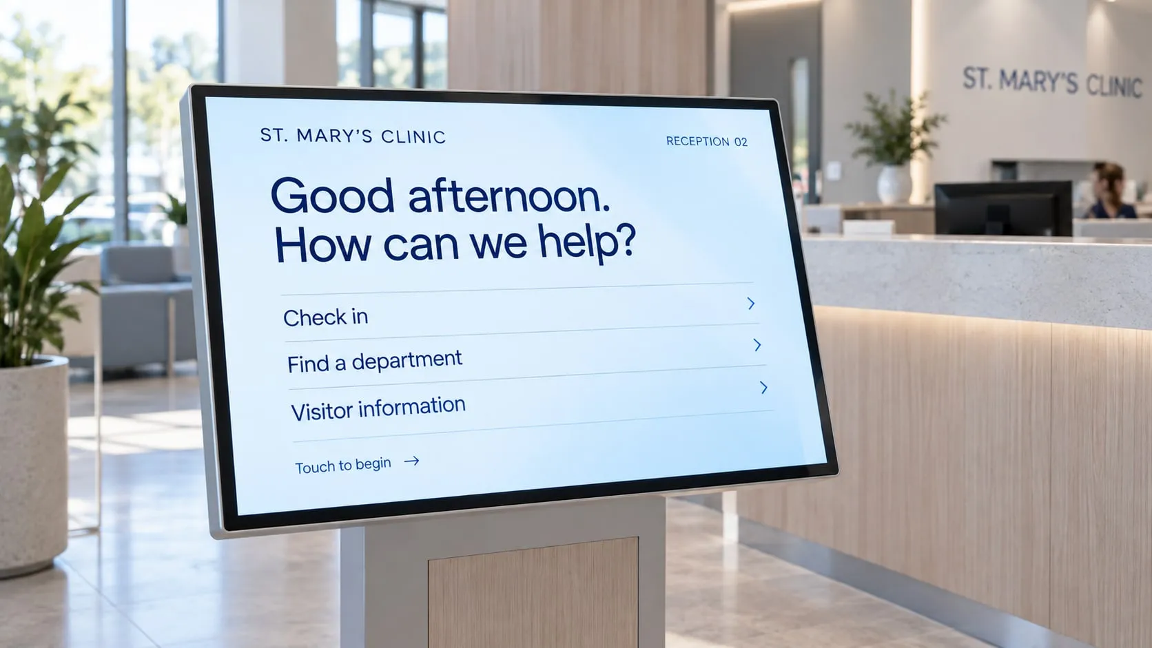 Touch screen kiosk at a clinic reception with buttons to check in, find a department or get visitor information