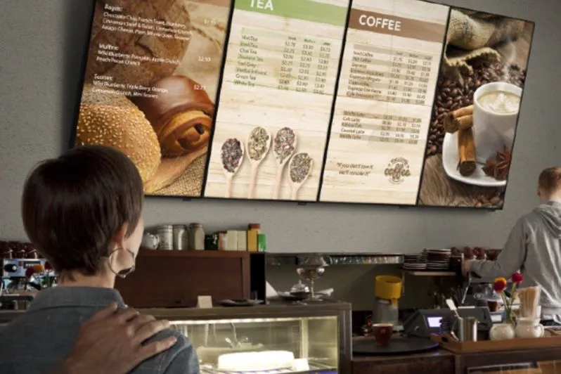 Employee looking at menu screens in a staff canteen