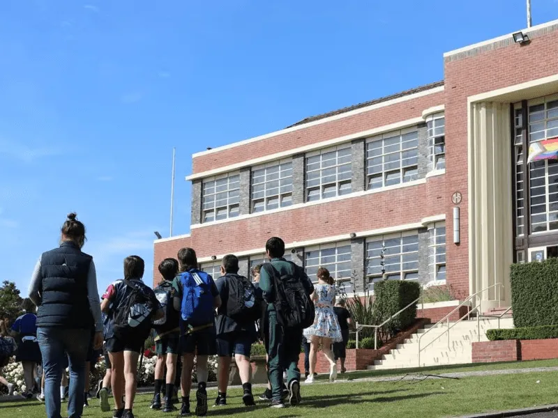 Students walking towards a school building