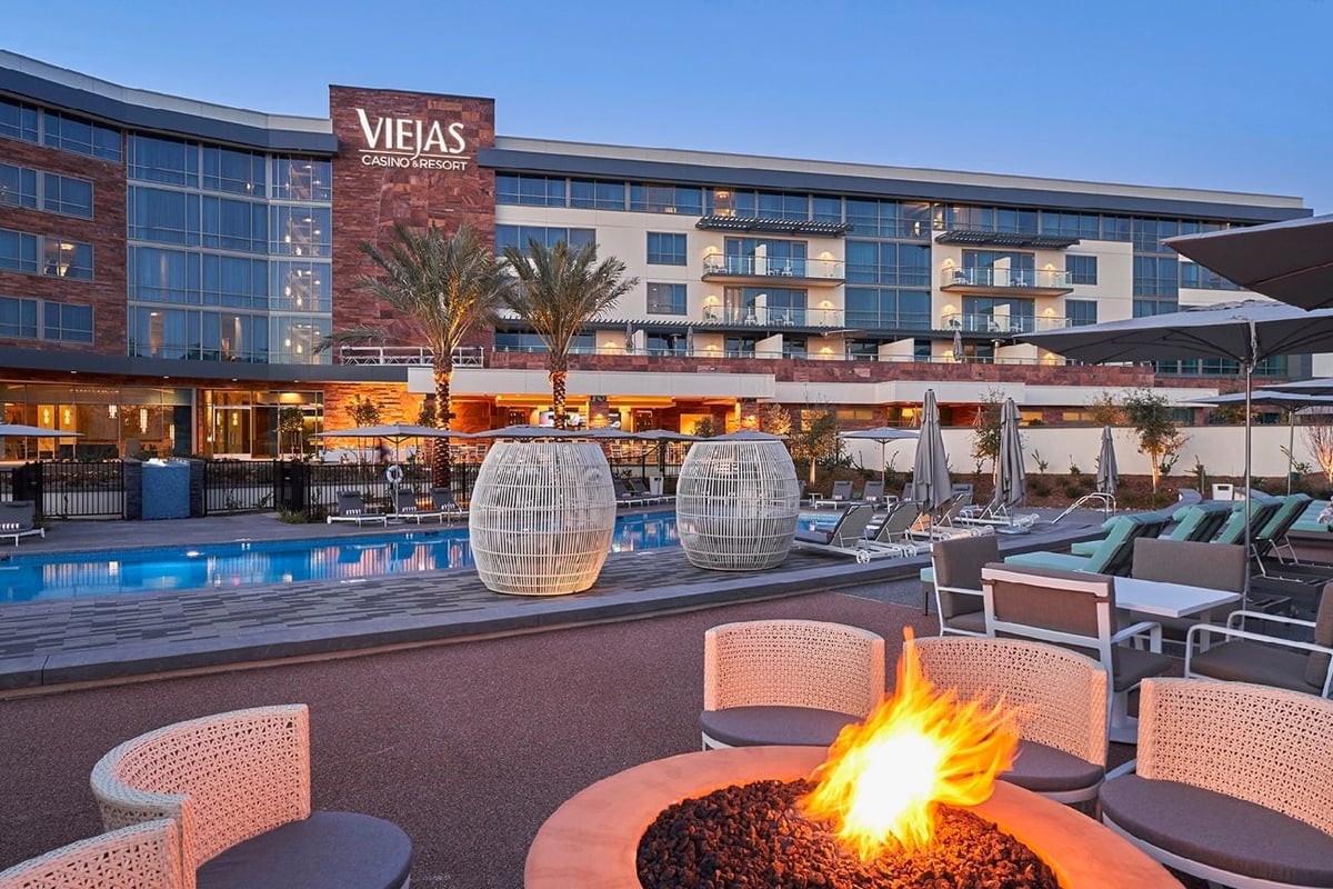 View of Viejas Casino & Resort from the poolside, featuring an open firepit and captivating lighting